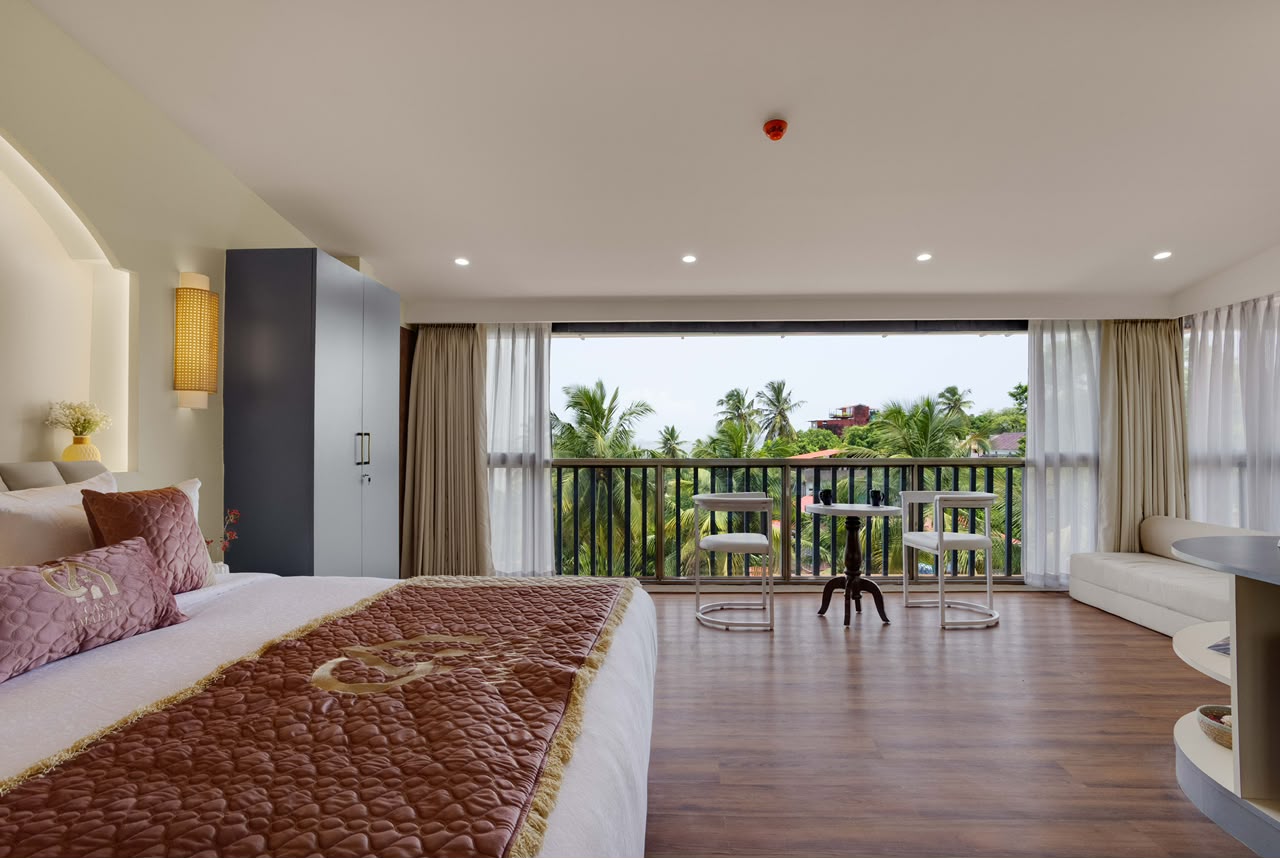 A room at Casa Amarilla opening onto a palm-facing balcony